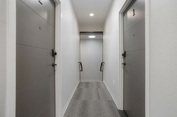 A long hallway with doors on both sides.